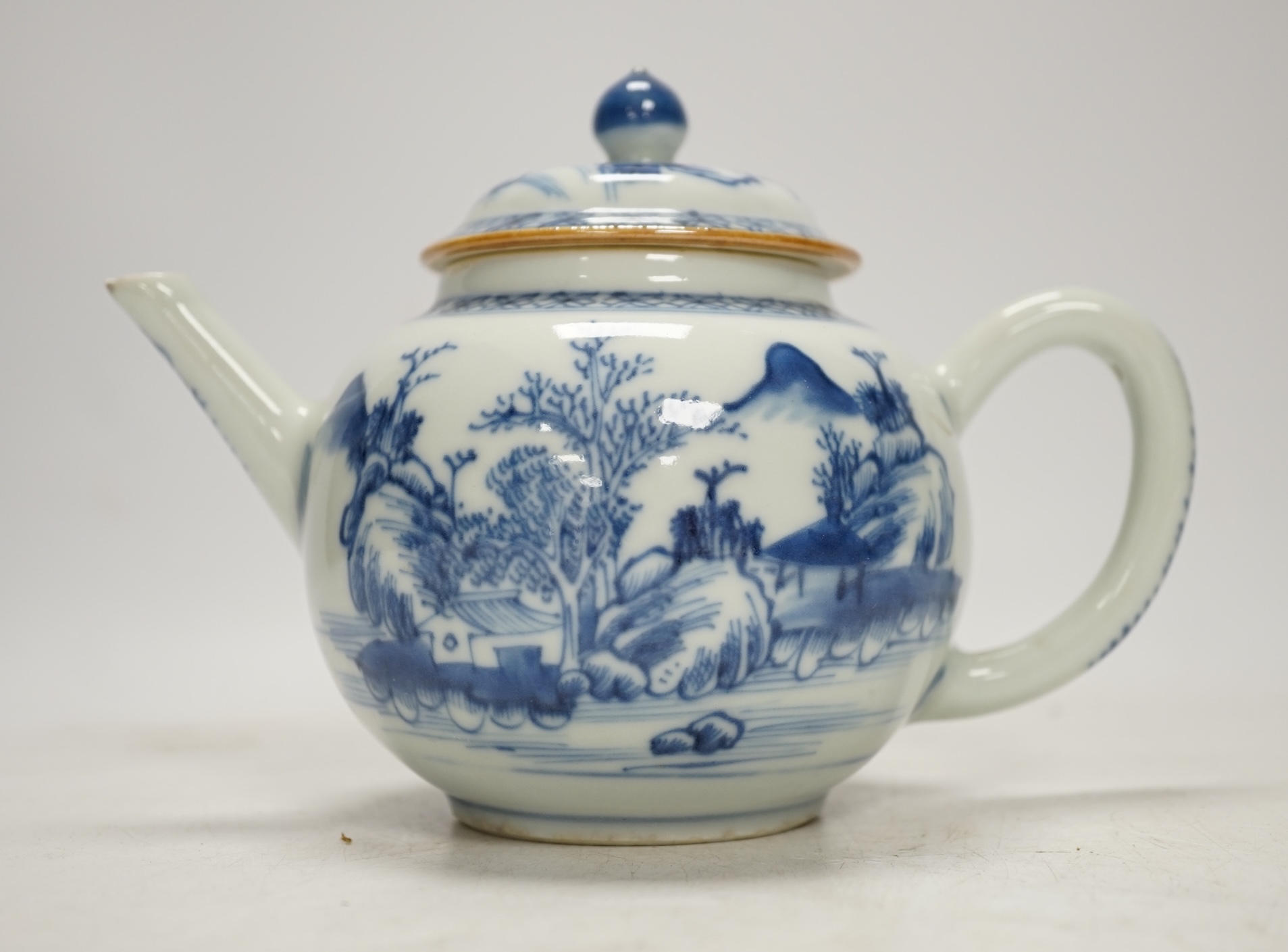An 18th century Chinese blue and white teapot and cover, 12cm high. Condition - poor